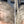 Before and after image of a person with short curly gray hair and thin hair on their parting line